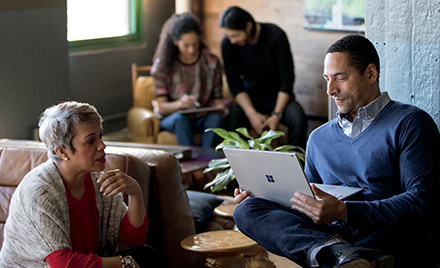 Image of two workers collaborating in a workspace.