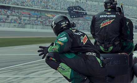 Image of two Hendrick Motorsports team members leaning over a track.