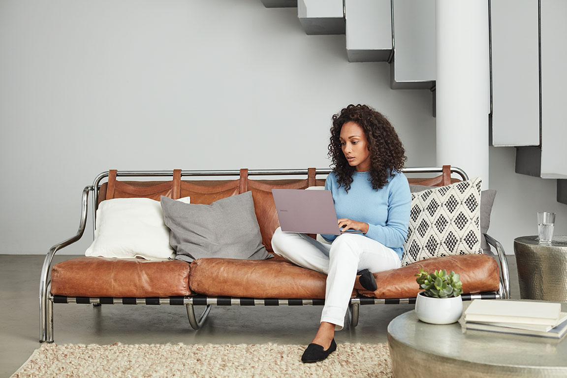 Image of a remote worker on her couch.